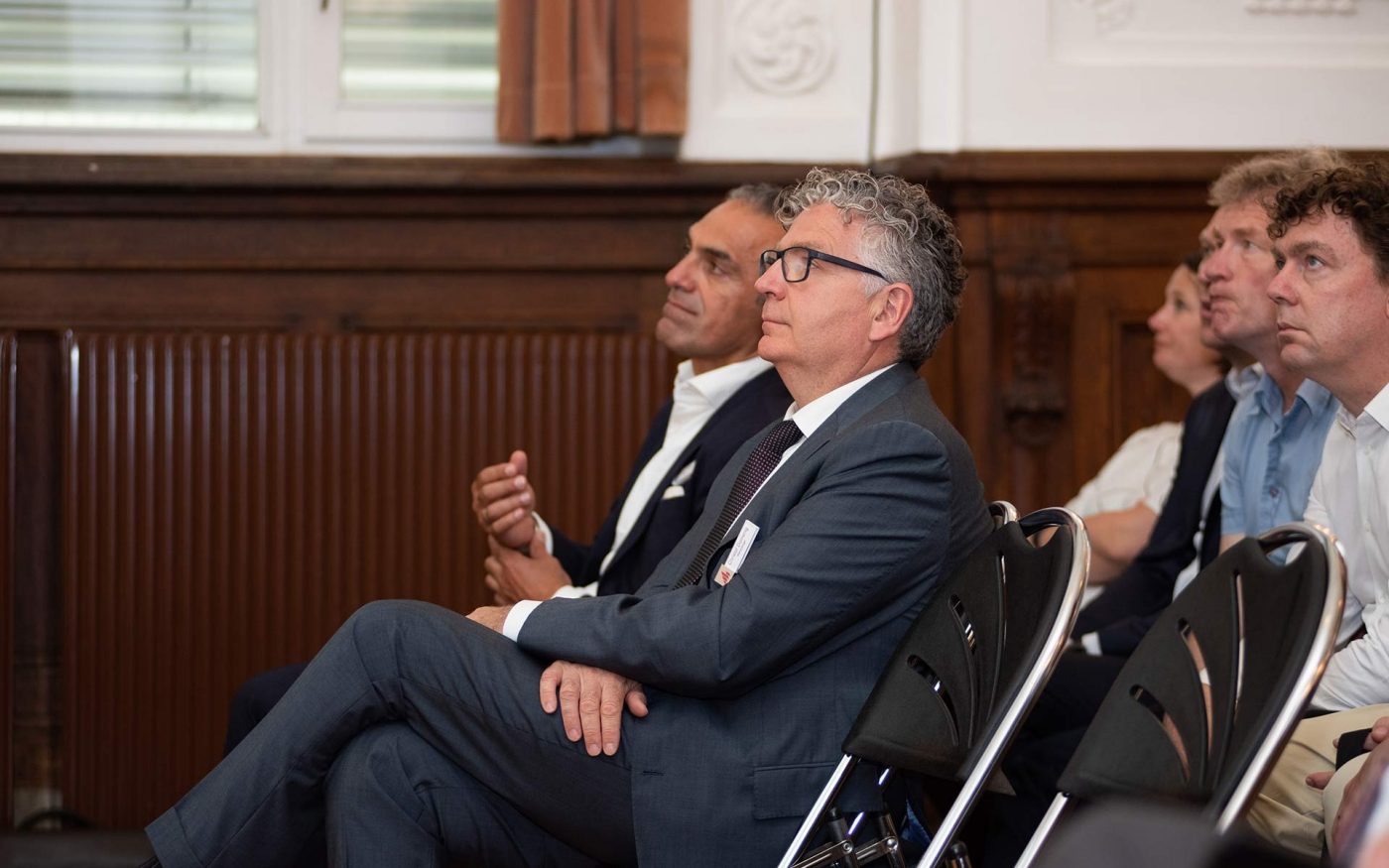 Guests listen Symposium speakers