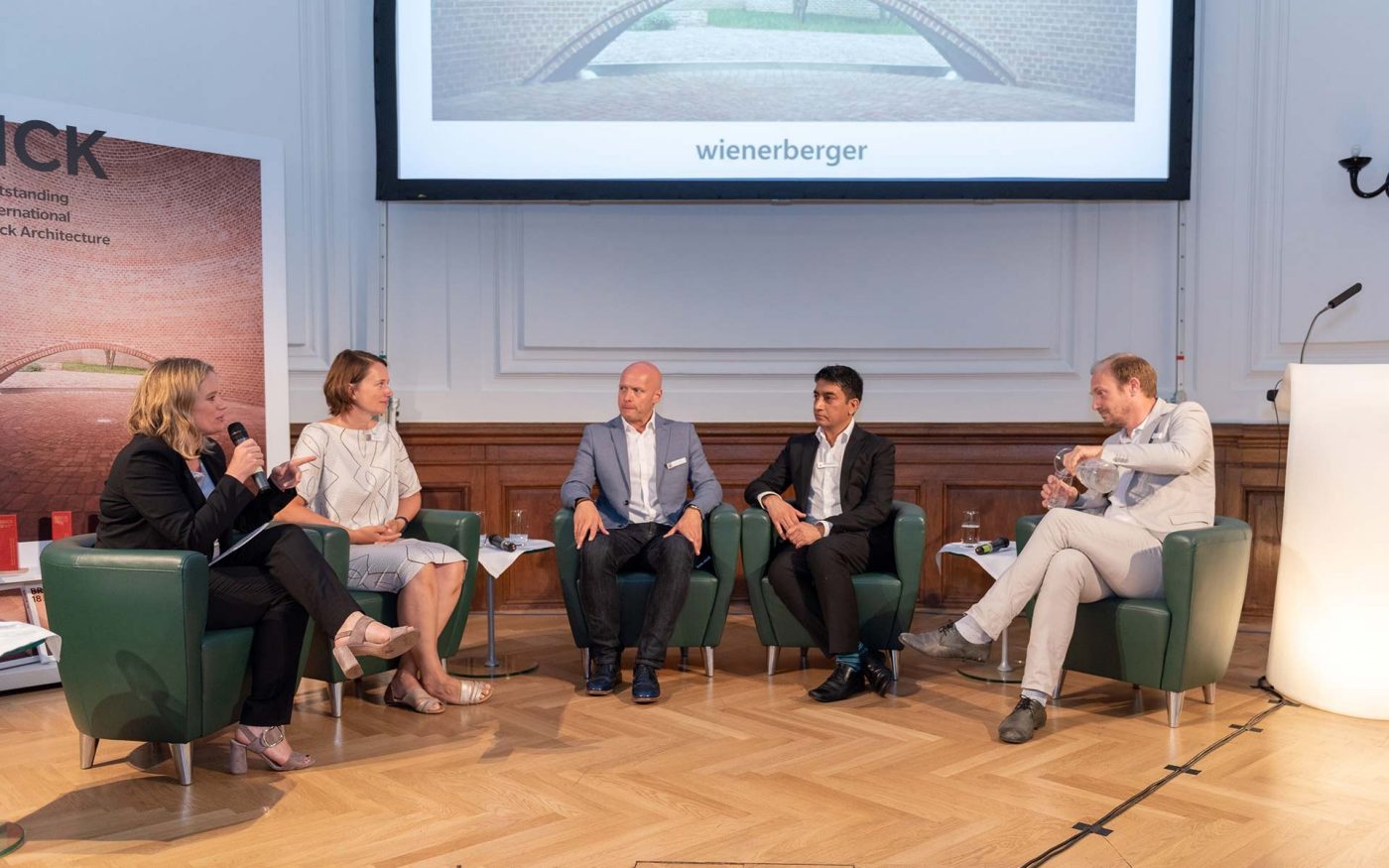Brick Award 18 Symposium, Corinna Milborn (moderation), Astrid Piber, UNStudio (key note speaker), Casey Rutland, Royal Haskoning DHV (speaker), Nitesh Magdani,  Royal BAM group (speaker), Job Floris, Monadnock (speaker)  on stage 